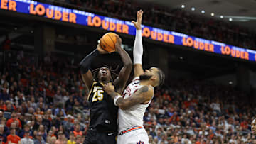 Missouri Tigers guard Mark Mitchell (25) attempts a layup on Auburn forward Johni Broome (4) in a game this season.