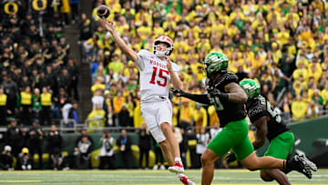 Oct 11, 2025; Eugene, Oregon, USA; Indiana Hoosiers quarterback Fernando Mendoza (15) throws a pass against Oregon Ducks defensive back Xavier Barksdale (30) during the first quarter  at Autzen Stadium. Mandatory Credit: Troy Wayrynen-Imagn Images