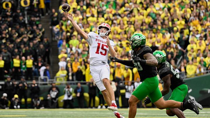 Oct 11, 2025; Eugene, Oregon, USA; Indiana Hoosiers quarterback Fernando Mendoza (15) throws a pass against Oregon Ducks defensive back Xavier Barksdale (30) during the first quarter  at Autzen Stadium. Mandatory Credit: Troy Wayrynen-Imagn Images