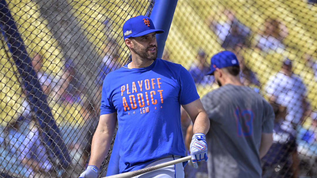 New York Mets designated hitter J.D. Martinez (28) warms up in batting cages
