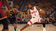 Houston Rockets guard Jalen Green controls the ball against Golden State Warriors guard Buddy Hield.