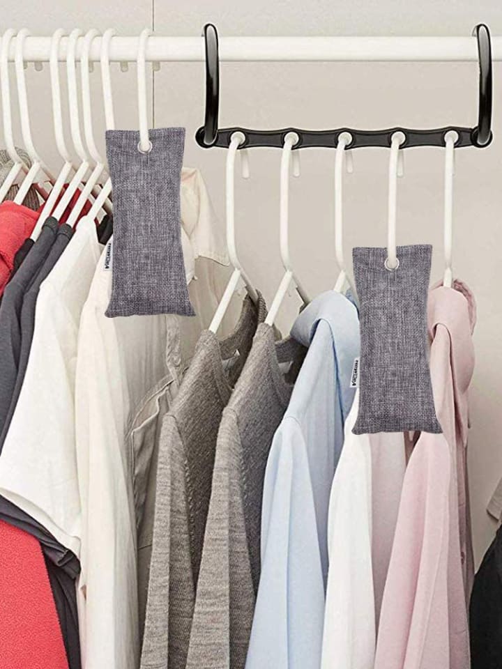 Bamboo charcoal air purifying bags hanging in closet with clothes