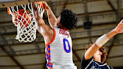 Kaden Powers goes airborne for a dunk as Rainier Beach rolled past Eastside Catholic in a WIAA Class 3A first-round game Wednesday.
