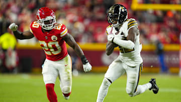 Oct 7, 2024; Kansas City, Missouri, USA; New Orleans Saints wide receiver Rashid Shaheed (22) runs with the ball  against Kansas City Chiefs safety Justin Reid (20) during the second half at GEHA Field at Arrowhead Stadium. Mandatory Credit: Jay Biggerstaff-Imagn Images