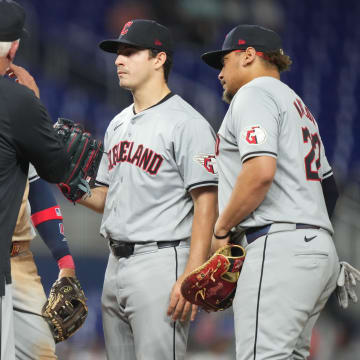 Jun 7, 2024; Miami, Florida, USA;  Cleveland Guardians starting pitcher Logan Allen (41) gets a visa to the mound from pitching coach Carl Willis (51) in the fifth inning against the Miami Marlins at loanDepot Park. Mandatory Credit: Jim Rassol-USA TODAY Sports