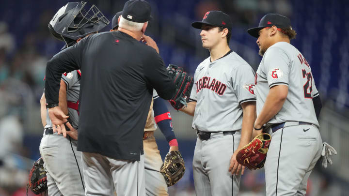 Jun 7, 2024; Miami, Florida, USA;  Cleveland Guardians starting pitcher Logan Allen (41) gets a visa to the mound from pitching coach Carl Willis (51) in the fifth inning against the Miami Marlins at loanDepot Park. Mandatory Credit: Jim Rassol-USA TODAY Sports