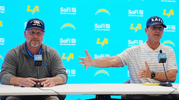 Jan 15, 2025; El Segundo, CA, USA; Los Angeles Chargers general manager Joe Hortiz (left) and coach Jim Harbaugh.