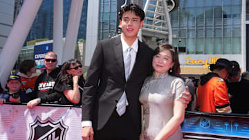 Jun 27, 2025; Los Angeles, California, USA; Simon Wang, with his mother, Willa, arrive to the first round of the 2025 NHL Draft at Peacock Theater.