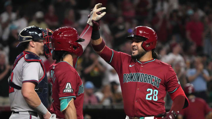 Jul 11, 2024; Phoenix, Arizona, USA; Arizona Diamondbacks third base Eugenio Suárez (28) celebrates with outfielder Corbin Carroll (7) after hitting a solo home run against the Atlanta Braves in the fifth inning at Chase Field. Mandatory Credit: Rick Scuteri-USA TODAY Sports