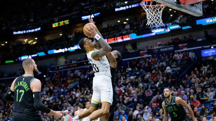 Jan 23, 2024; New Orleans, Louisiana, USA; Utah Jazz forward John Collins (20) shoots against New Orleans Pelicans forward Naji Marshall during the second half at Smoothie King Center. Mandatory Credit: Matthew Hinton-USA TODAY Sports