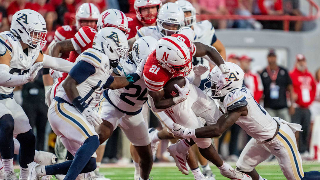 Nebraska Cornhuskers running back Emmett Johnson (21) runs against Akron Zips defensive back Malcom DeWalt IV (17) Nebraska Cornhuskers running back Emmett Johnson (21) runs against Akron Zips defensive back Malcom DeWalt IV (17)