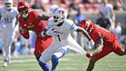 Oct 5, 2024; Louisville, Kentucky, USA;  Southern Methodist Mustangs running back Brashard Smith (1) runs the ball against Louisville Cardinals defensive back Tamarion McDonald (12) during the second half at L&N Federal Credit Union Stadium. Mandatory Credit: Jamie Rhodes-Imagn Images