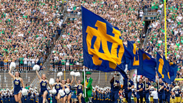 Sep 20, 2025; South Bend, Indiana, USA; The Notre Dame Leprechaun runs onto the field with an ND flag and cheerleaders before the game against Purdue at Notre Dame Stadium. Mandatory Credit: Michael Caterina-Imagn Images