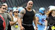 UFL owner Dwayne Johnson aka The Rock walks off the field before the game between the Arlington Renegades and the Birmingham Stallions at Choctaw Stadium. 