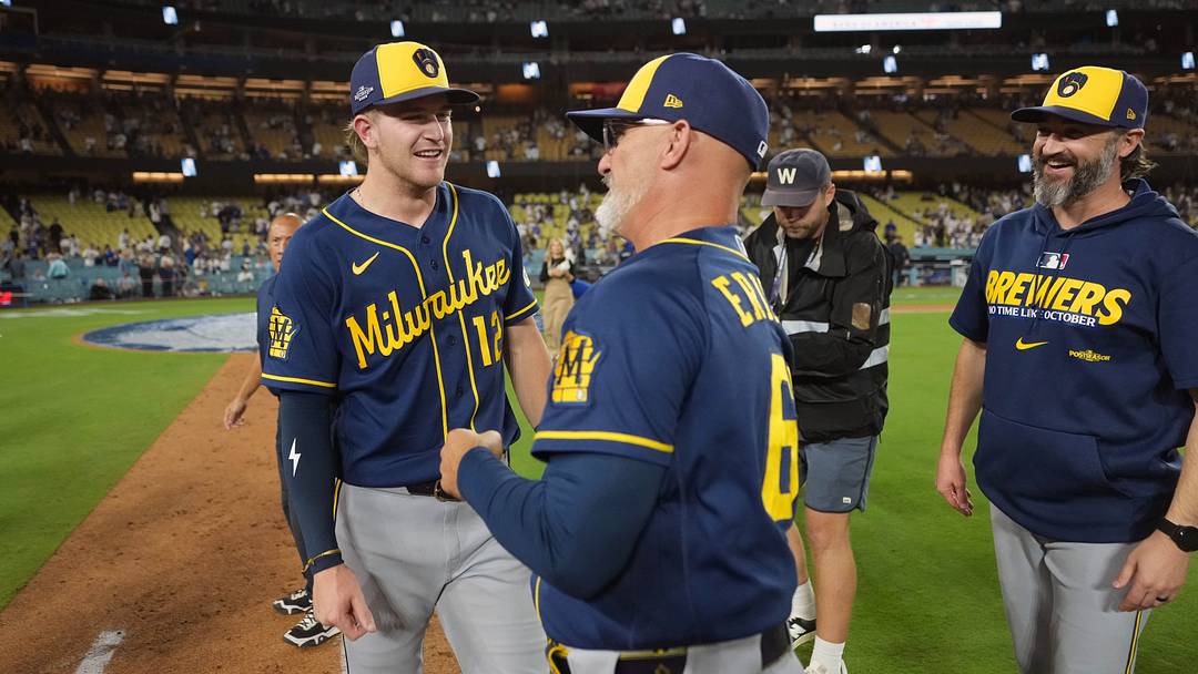 Oct 15, 2026; Los Angeles, California, USA; Milwaukee Brewers shortstop Cooper Pratt (12) and third base coach Matt Erickson (68) celebrate after game four of the NLCS for the 2026 MLB Playoffs against the Los Angeles Dodgers at Uniqlo Field at Dodger Stadium. Mandatory Credit: Kirby Lee-Imagn Images