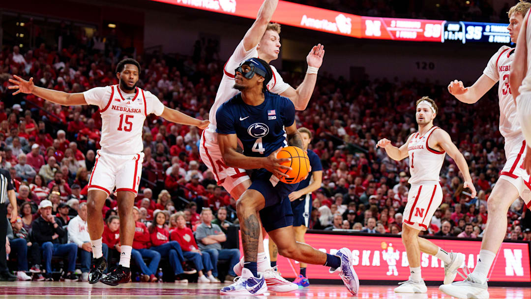 Feb 21, 2026; Lincoln, Nebraska, USA; Penn State Nittany Lions guard Kayden Mingo (4) drives against Nebraska Cornhuskers guard Cale Jacobsen (31) during the second half at Pinnacle Bank Arena. Mandatory Credit: Dylan Widger-Imagn Images