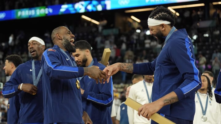 Aug 10, 2024; Paris, France; United States forward LeBron James (6) and center Anthony Davis (14) celebrate after defeating France in the men's basketball gold medal game during the Paris 2024 Olympic Summer Games at Accor Arena. Mandatory Credit: Kyle Terada-USA TODAY Sports