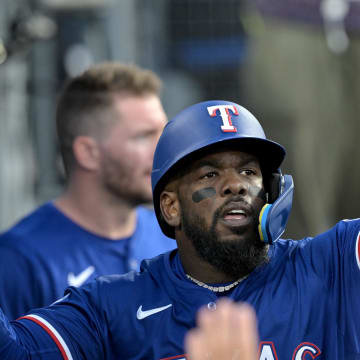 Jun 13, 2024; Los Angeles, California, USA;  Texas Rangers right fielder Adolis Garcia #53 is greeted in the dugout after scoring a run in the third inning against the Los Angeles Dodgers at Dodger Stadium. Mandatory Credit: Jayne Kamin-Oncea-USA TODAY Sports