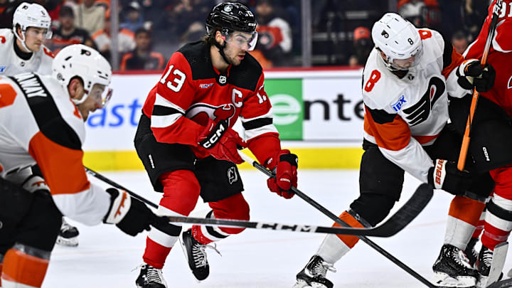 Apr 13, 2024; Philadelphia, Pennsylvania, USA; New Jersey Devils center Nico Hischier (13) chases the puck against the Philadelphia Flyers in the second period at Wells Fargo Center. Mandatory Credit: Kyle Ross-Imagn Images