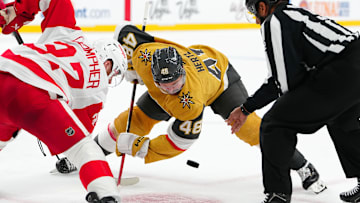 Mar 22, 2025; Las Vegas, Nevada, USA; Vegas Golden Knights center Tomas Hertl (48) takes a face-off against Detroit Red Wings left wing J.T. Compher (37) during the first period at T-Mobile Arena. Mandatory Credit: Stephen R. Sylvanie-Imagn Images