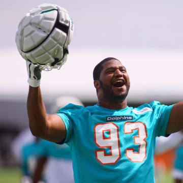 Jul 28, 2024; Miami Gardens, FL, USA; Miami Dolphins defensive tackle Calais Campbell (93) reacts toward the fans during training camp at Baptist Health Training Complex.