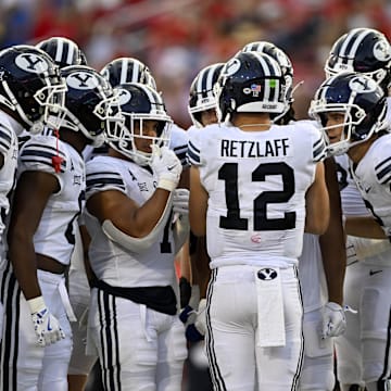 Sep 6, 2024; Dallas, Texas, USA; Brigham Young Cougars quarterback Jake Retzlaff (12) huddles with his team during the game between the Southern Methodist Mustangs and the Brigham Young Cougars at Gerald J. Ford Stadium.