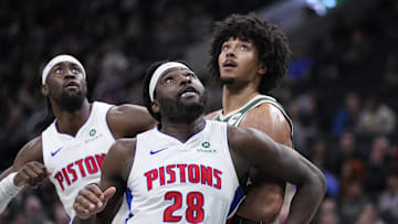 Dec 3, 2025; Milwaukee, Wisconsin, USA; Detroit Pistons forward Isaiah Stewart (28) and Milwaukee Bucks center Jericho Sims (00) box out for a free throw attempt in the first half at Fiserv Forum. Mandatory Credit: Michael McLoone-Imagn Images