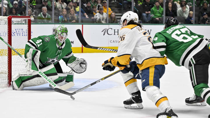 Jan 6, 2024; Dallas, Texas, USA; Dallas Stars goaltender Scott Wedgewood (41) stops a shot by Nashville Predators center Philip Tomasino (26) as Dallas Stars right wing Evgenii Dadonov (63) defends during the first period at the American Airlines Center. Mandatory Credit: Jerome Miron-USA TODAY Sports