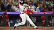 Sep 13, 2025; Seattle, Washington, USA; Seattle Mariners catcher Cal Raleigh (29) hits a single against the Los Angeles Angels during the fifth inning at T-Mobile Park. Mandatory Credit: Steven Bisig-Imagn Images