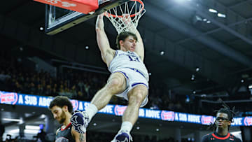 Dec 29, 2024; Evanston, Illinois, USA;  Northwestern Wildcats guard Brooks Barnhizer (13) dunks the ball against the Northeastern Huskies during the second half at Welsh-Ryan Arena. Mandatory Credit: Matt Marton-Imagn Images