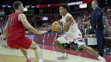 Wisconsin guard John Tonje (9) makes a move on UW-River Falls guard Zac Johnson (23) 