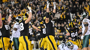 Nov 22, 2025; Iowa City, Iowa, USA; Iowa Hawkeyes offensive lineman Cannon Leonard (center) and teammates celebrate at the end of the game against the Michigan State Spartans at Kinnick Stadium. Mandatory Credit: Jeffrey Becker-Imagn Images