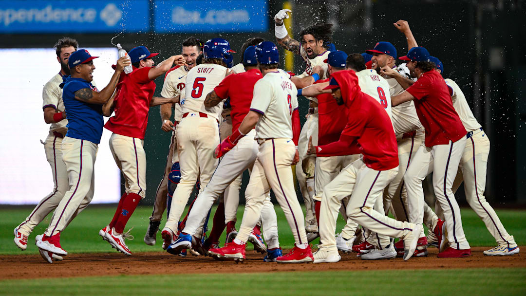 Oct 6, 2024; Philadelphia, Pennsylvania, USA; Philadelphia Phillies outfielder Nick Castellanos (8) celebrates with teammates after hitting a walk-off single against the New York Mets in the ninth inning during game two of the NLDS for the 2024 MLB Playoffs at Citizens Bank Park. 