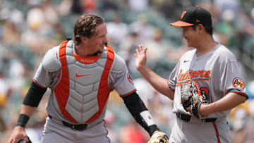 Jun 8, 2025; West Sacramento, California, USA; Baltimore Orioles starting pitcher Tomoyuki Sugano (right) is congratulated by catcher Adley Rutschman (left) after the final out of the fourth inning against the Athletics at Sutter Health Park. Mandatory Credit: Darren Yamashita-Imagn Images