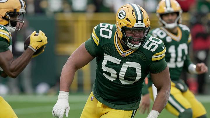 Green Bay Packers offensive tackle Zach Tom (50) leads a running back during the third quarter of their game against the Minnesota Vikings Sunday, November 23, 2025 at Lambeau Field in Green Bay, Wisconsin.