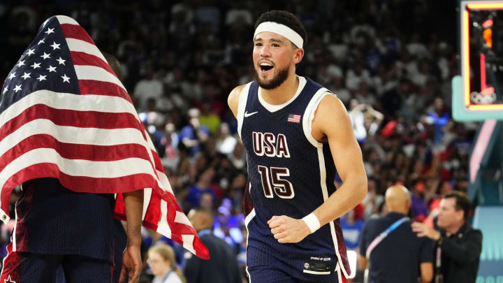 Aug 10, 2024; Paris, France; United States guard Devin Booker (15) celebrates after defeating France in the men's basketball gold medal game during the Paris 2024 Olympic Summer Games at Accor Arena. Mandatory Credit: Rob Schumacher-USA TODAY Sports