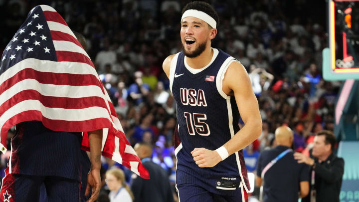 Aug 10, 2024; Paris, France; United States guard Devin Booker (15) celebrates after defeating France in the men's basketball gold medal game during the Paris 2024 Olympic Summer Games at Accor Arena. Mandatory Credit: Rob Schumacher-USA TODAY Sports