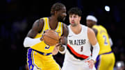 Oct 27, 2025; Los Angeles, California, USA; Los Angeles Lakers center Deandre Ayton (5) looks to pass the ball while under pressure from Portland Trail Blazers forward Deni Avdija (8) during the first half at Crypto.com Arena. Mandatory Credit: William Liang-Imagn Images