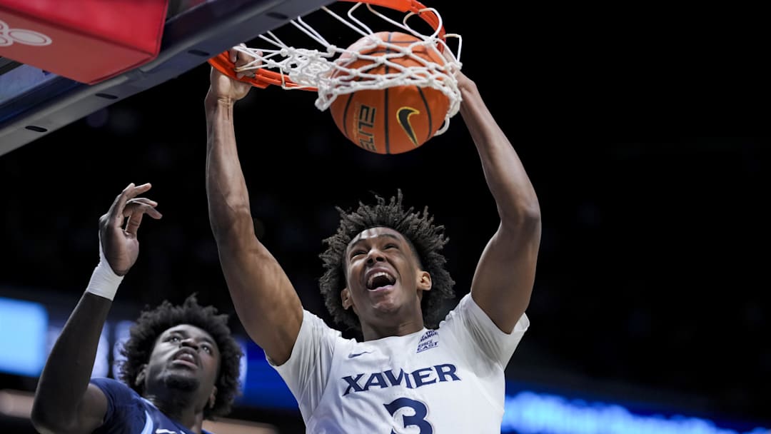 Jan 14, 2025; Cincinnati, Ohio, USA;  Xavier Musketeers guard Dailyn Swain (3) dunks the ball against Villanova Wildcats forward Enoch Boakye (13) in the first half at the Cintas Center. Mandatory Credit: Aaron Doster-Imagn Images