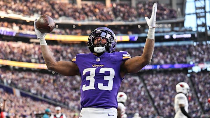 Dec 1, 2024; Minneapolis, Minnesota, USA; Minnesota Vikings running back Aaron Jones (33) reacts after scoring the game winning touchdown against the Arizona Cardinals during the fourth quarter at U.S. Bank Stadium.
