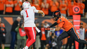 Sep 26, 2025; Corvallis, Oregon, USA; Houston Cougars quarterback Conner Weigman (1) throws a pass under pressure from Oregon State Beavers linebacker Aiden Sullivan (2) during the first quarter at Reser Stadium. Mandatory Credit: Craig Strobeck-Imagn Images