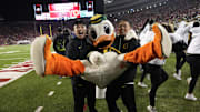 Nov 16, 2024; Madison, Wisconsin, USA;  Oregon Ducks mascot The Duck performs with cheerleaders during the game against the Wisconsin Badgers at Camp Randall Stadium. Mandatory Credit: Jeff Hanisch-Imagn Images