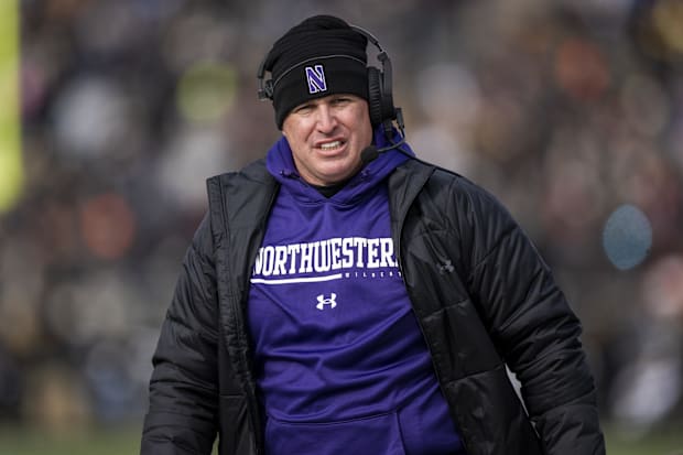 Former Northwestern coach Pat Fitzgerald walks the sideline.