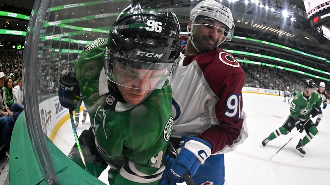 Apr 4, 2026; Dallas, Texas, USA; Colorado Avalanche center Nazem Kadri (91) checks Dallas Stars right wing Mikko Rantanen (96) during the second period at the American Airlines Center. Mandatory Credit: Jerome Miron-Imagn Images