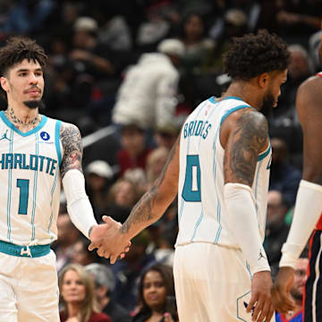 Oct 26, 2025; Washington, District of Columbia, USA; Charlotte Hornets guard LaMelo Ball (1) celebrates with center Ryan Kalkbrenner (11) and forward Miles Bridges (0) against the Washington Wizards during the fourth quarter at Capital One Arena. Mandatory Credit: Rafael Suanes-Imagn Images