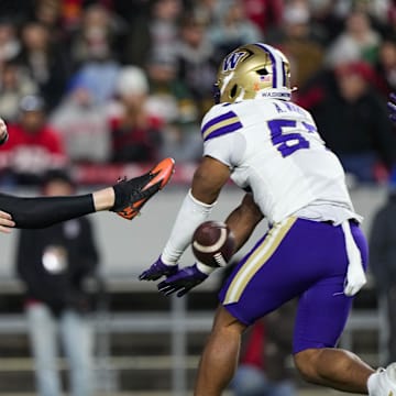 Nov 8, 2025; Madison, Wisconsin, USA;  Washington Huskies linebacker Anthony Ward (57) blocks the punt from Wisconsin Badgers kicker Sean West (91) during the second quarter at Camp Randall Stadium. Mandatory Credit: Jeff Hanisch-Imagn Images