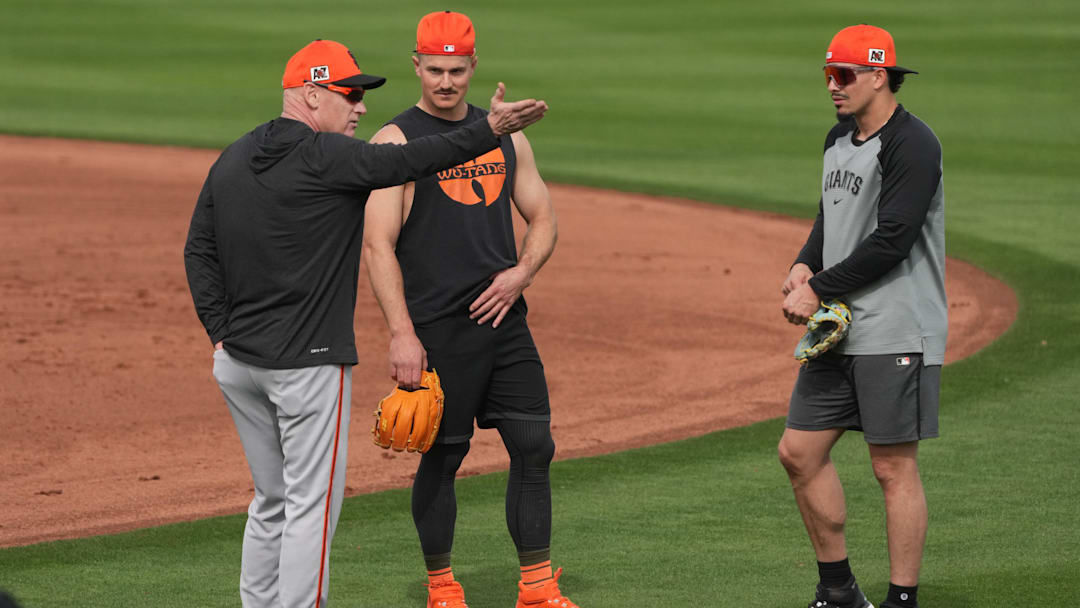 Feb 13, 2025; Scottsdale, AZ, USA; San Francisco Giants coach Matt Williams talks to third base Matt Chapman (26) and shortstop Willy Adames (2) talk during spring training camp. 