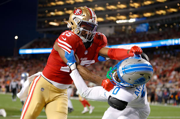 San Francisco 49ers wide receiver Jauan Jennings (15) and Detroit Lions cornerback Terrion Arnold (0) get tangled after a pla