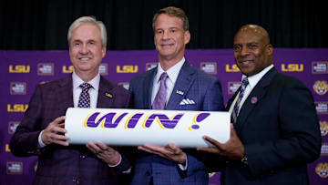 Dec 1, 2025; Baton Rouge, LA, USA; LSU president Wade Rousse, left, LSU new head coach Lane Kiffin and LSU athletic director Verge Ausberry stand together at South Stadium Club at Tiger Stadium. Mandatory Credit: Matthew Hinton-Imagn Images