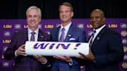 Dec 1, 2025; Baton Rouge, LA, USA; LSU president Wade Rousse, left, LSU new head coach Lane Kiffin and LSU athletic director Verge Ausberry stand together at South Stadium Club at Tiger Stadium. Mandatory Credit: Matthew Hinton-Imagn Images